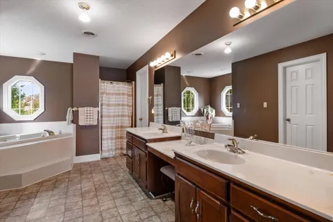 a patio with a table and chairs and potted plants