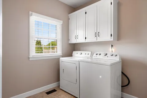 a backyard of a house with yard table and chairs