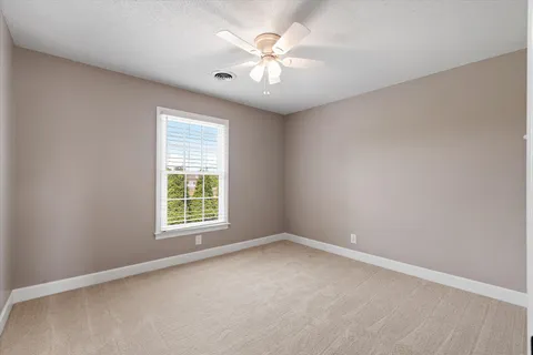a bathroom with a bathtub and next to a window