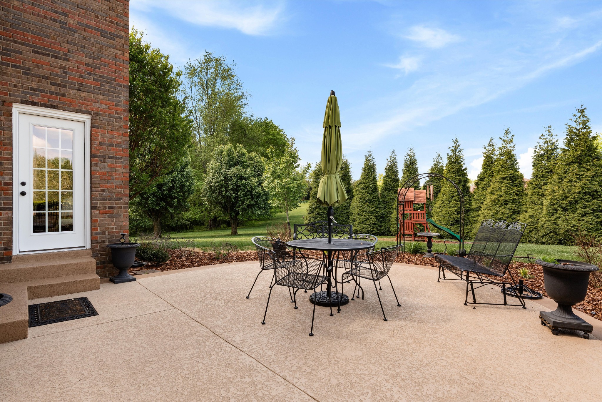 506 Pond Apple Road Clarksville, TN 37043 - Photo 42 of 73 a view of a patio with a table chairs and a floor to ceiling window
