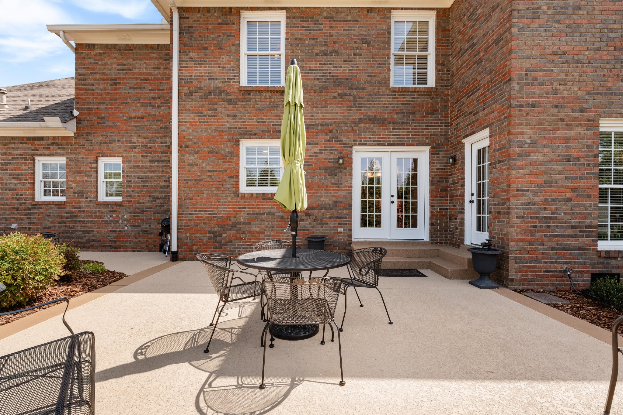 506 Pond Apple Road Clarksville, TN 37043 - Photo 43 of 73 a patio with a table and chairs and potted plants