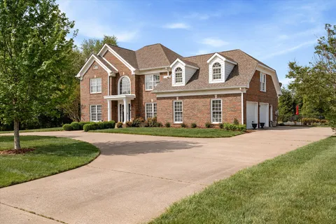 a view of a dining room with furniture a chandelier and wooden floor