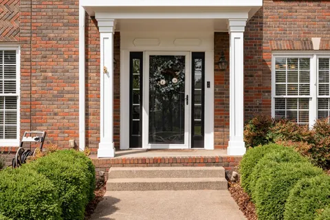 a view of an entryway with wooden floor and windows
