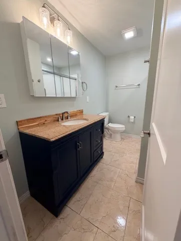a bathroom with a sink vanity and mirror