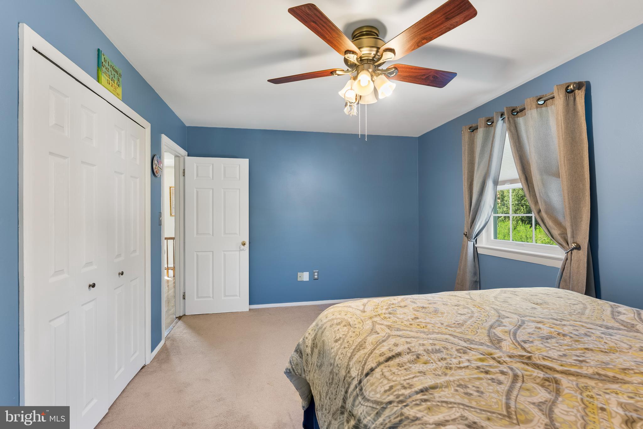907 Arran Road Baltimore, MD 21239 - Photo 24 of 41 a bedroom with a large bed and a chandelier