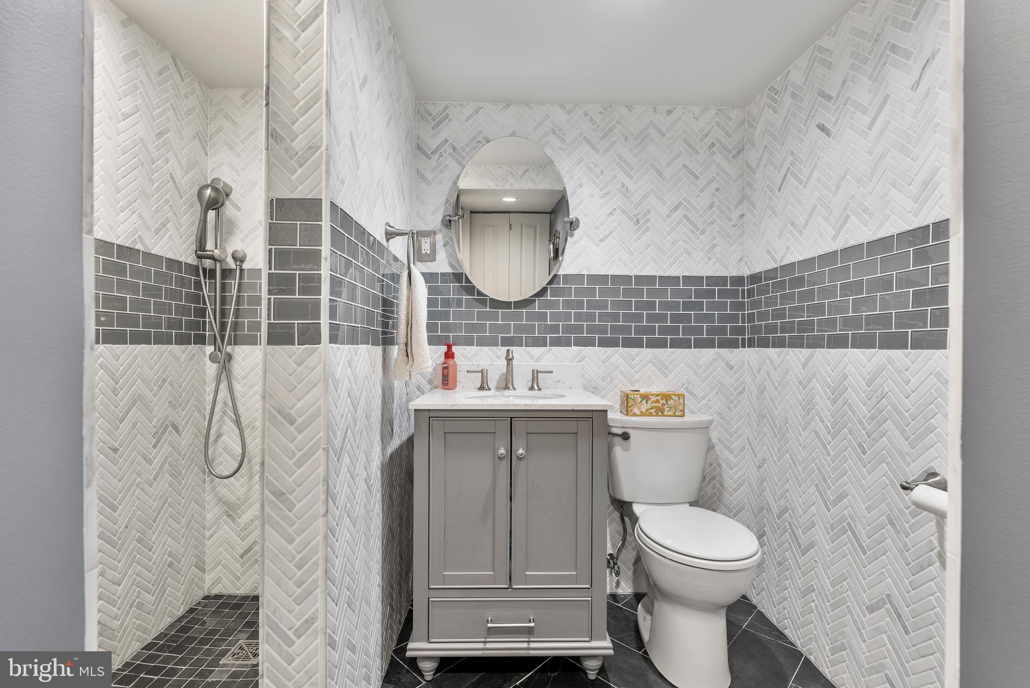 907 Arran Road Baltimore, MD 21239 - Photo 28 of 41 a bathroom with a toilet sink and mirror