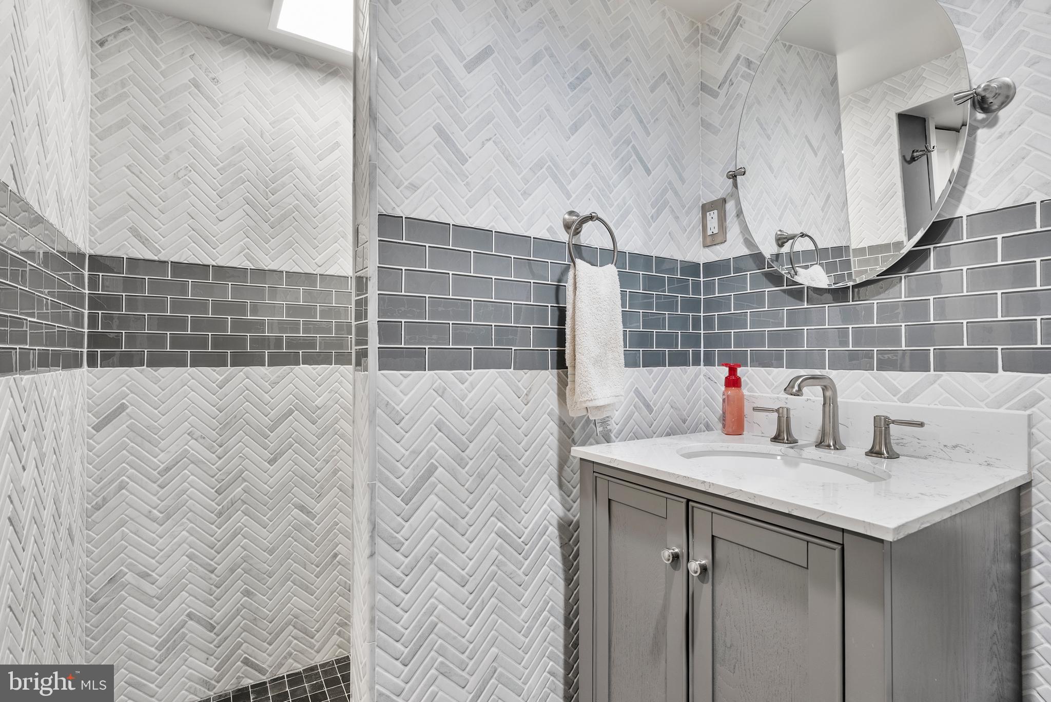 907 Arran Road Baltimore, MD 21239 - Photo 29 of 41 a bathroom with a sink and a mirror