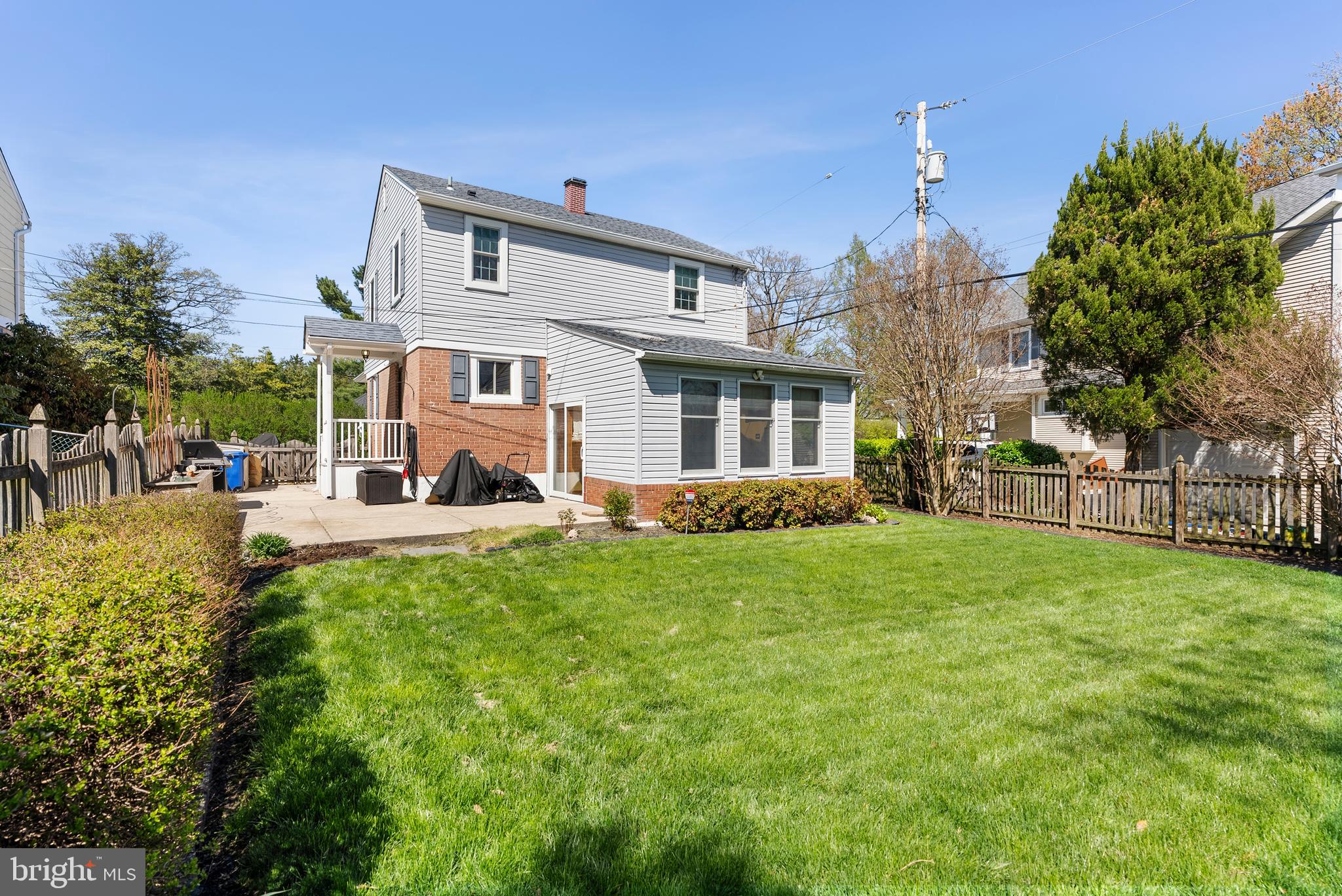 907 Arran Road Baltimore, MD 21239 - Photo 36 of 41 a view of a white house in front of a big yard with plants and large trees