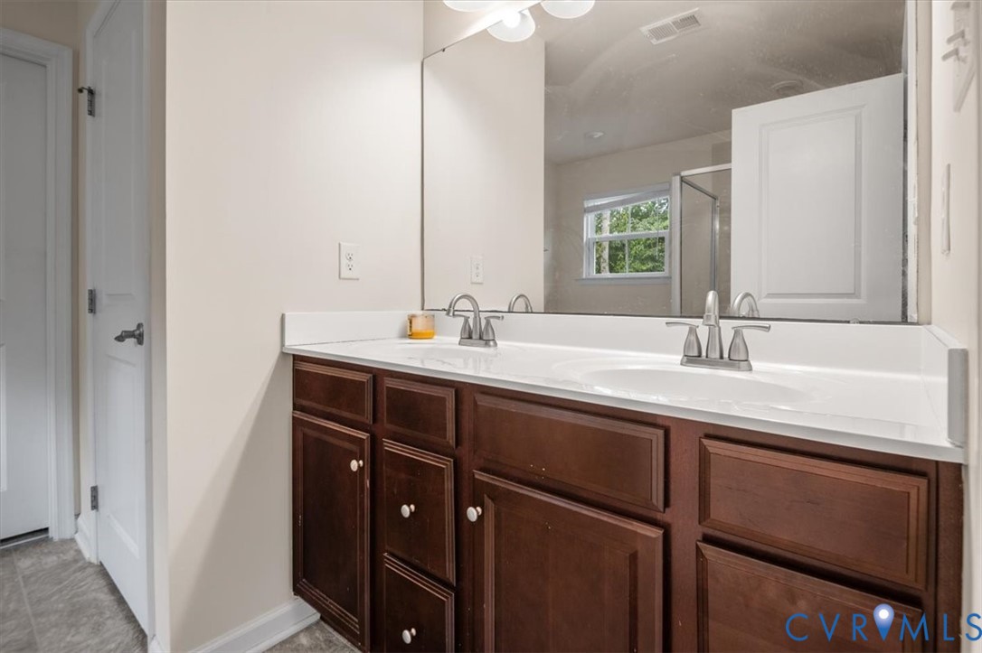 9013 Bailey Hill Road Midlothian, VA 23112 - Photo 36 of 56 Dual sink vanity with dark wood-finish cabinetry,