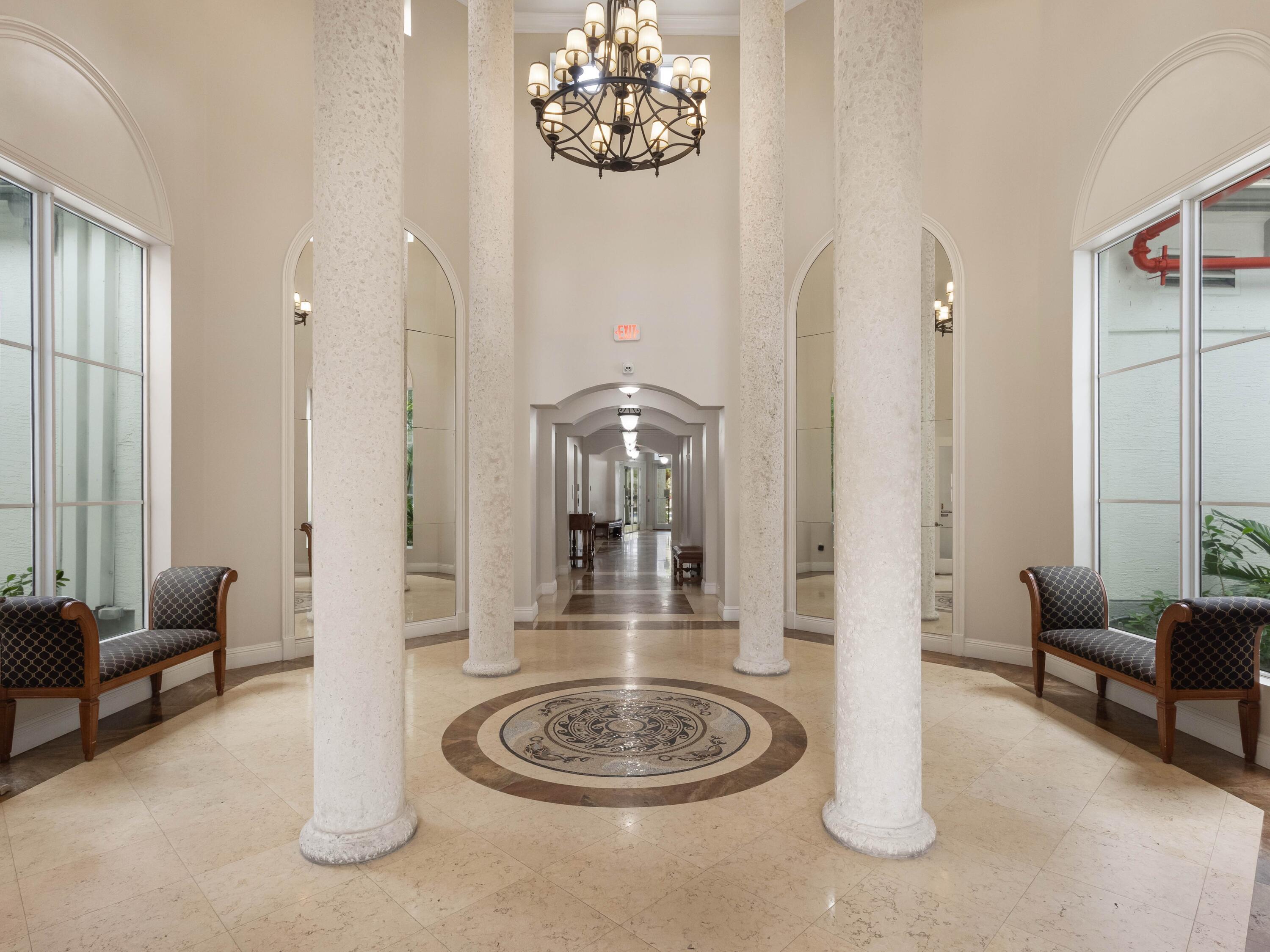 1690 Renaissance Commons Boulevard, Unit 1412 Boynton Beach, FL 33426 - Photo 35 of 49 a dining room with furniture and a chandelier