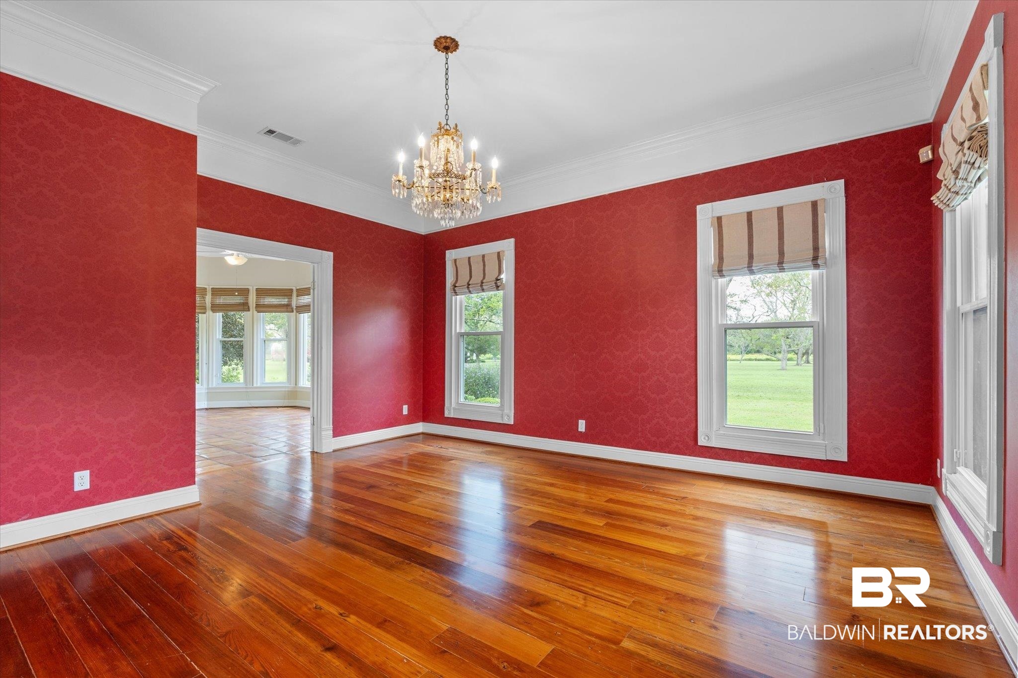 5231 Dawes Road Grand Bay, AL 36541 - Photo 8 of 49 Unfurnished room featuring wood-type flooring, crown molding, and a notable chandelier