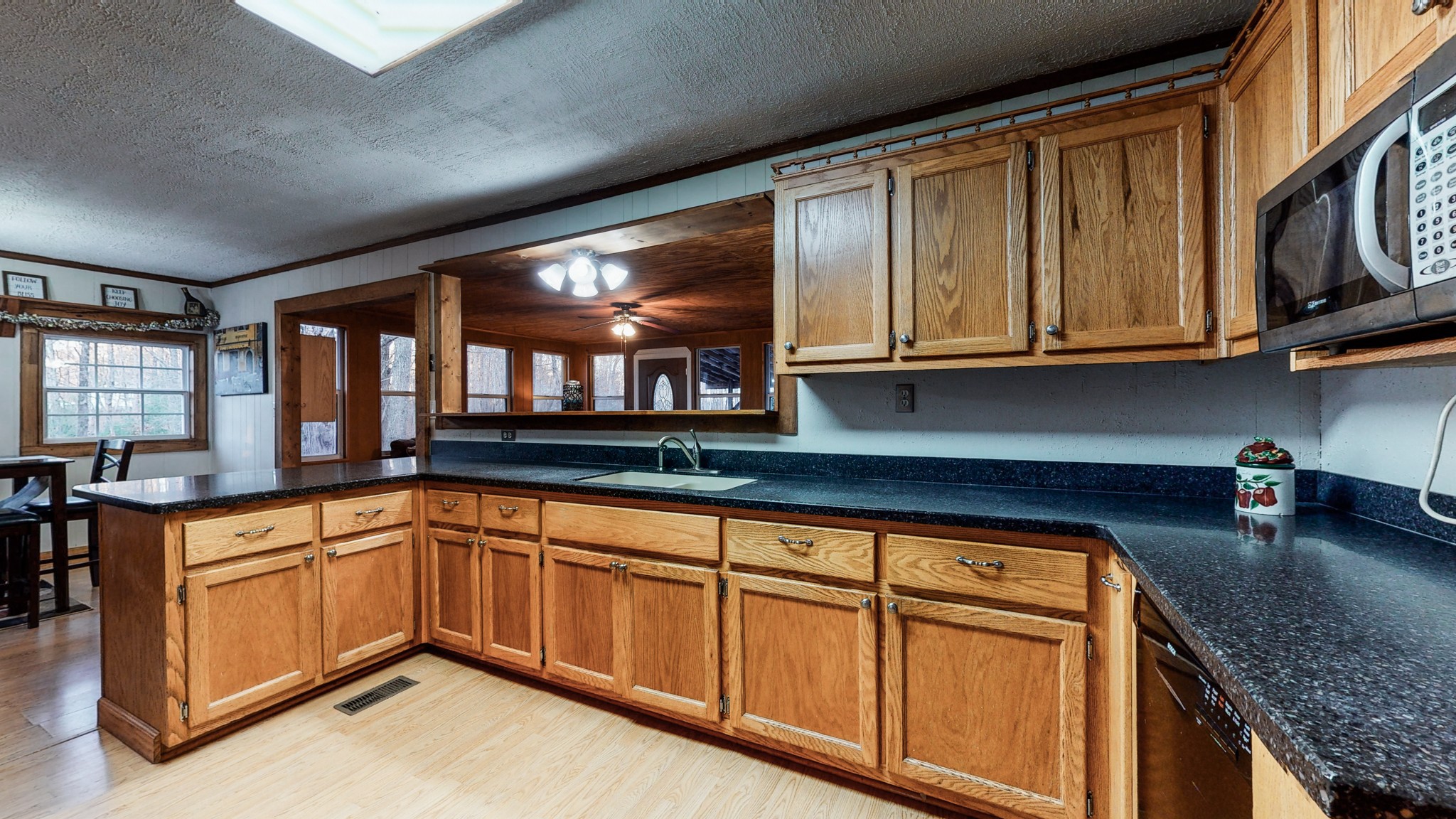 1225 Manley Loop Dickson, TN 37055 - Photo 18 of 50 a kitchen with granite countertop cabinets stainless steel appliances a sink and a window