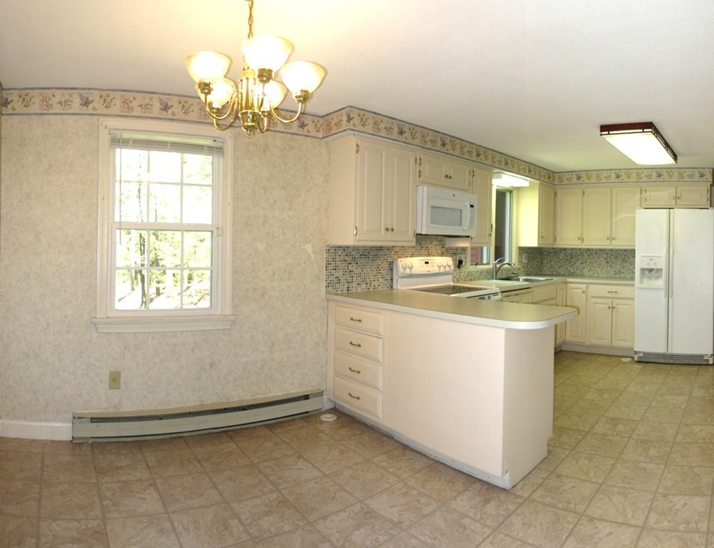 105 Heatherstone Road Amherst, MA 01002 - Photo 3 of 25 a kitchen that has a lot of white cabinets and stainless steel appliances