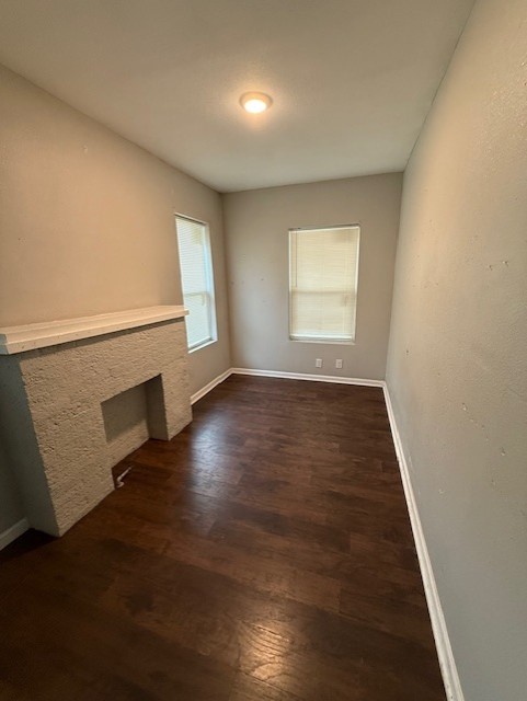 1507 7th Street Corpus Christi, TX 78404 - Photo 5 of 9 an empty room with wooden floor and windows
