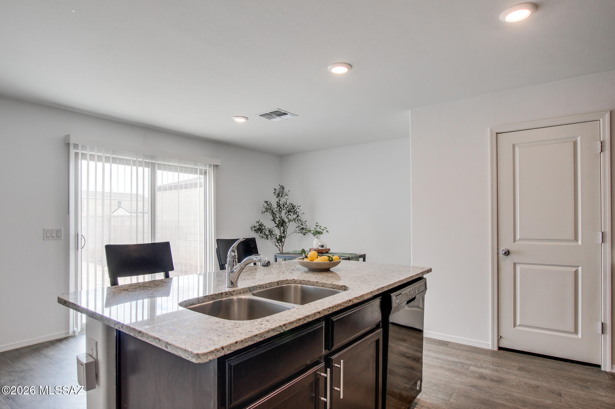 5987 South Antrim Loop Tucson, AZ 85706 - Photo 13 of 34 a kitchen with a sink and a refrigerator