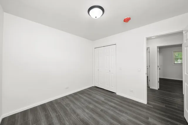 a view of a room with wooden floor and window
