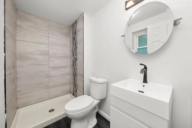 a bathroom with a sink toilet and shower