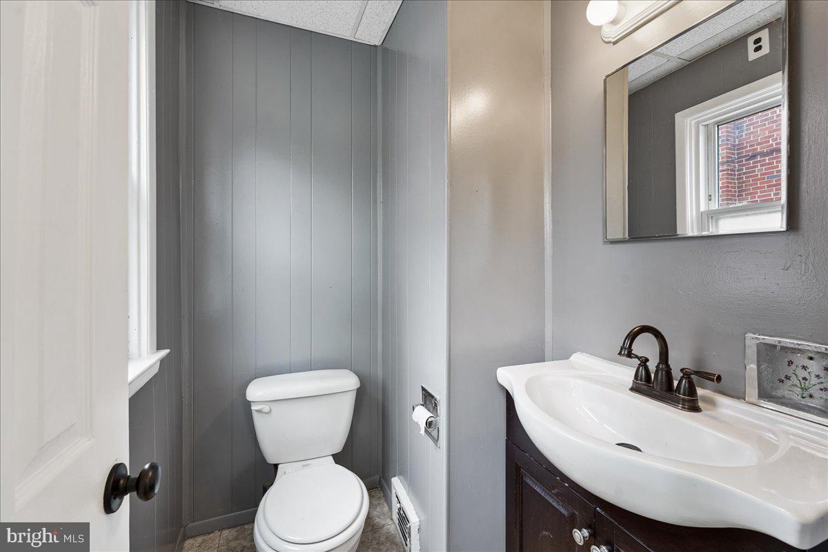 1107 Haverford Road Ridley Park, PA 19078 - Photo 14 of 17 a bathroom with a toilet a sink and mirror
