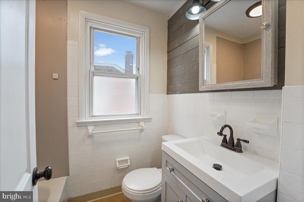 1107 Haverford Road Ridley Park, PA 19078 - Photo 5 of 17 a bathroom with a sink a toilet and mirror