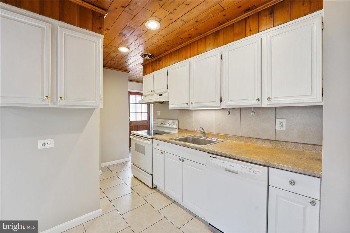 1107 Haverford Road Ridley Park, PA 19078 - Photo 10 of 17 a kitchen with granite countertop white cabinets and stainless steel appliances