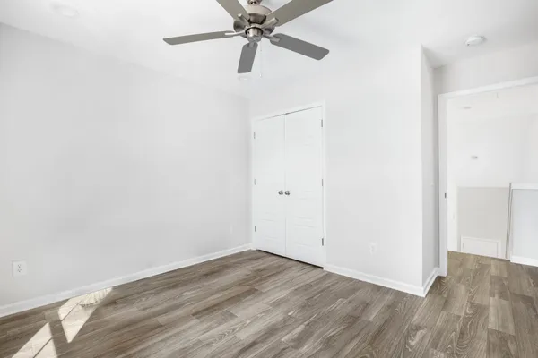a view of a room with wooden floor