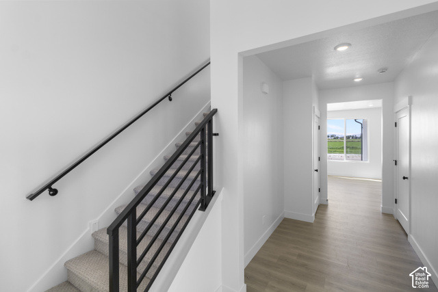 537 South 1150 West Logan, UT 84321 - Photo 18 of 33 Staircase with black metal horizontal balusters and a wall-mounted handrail