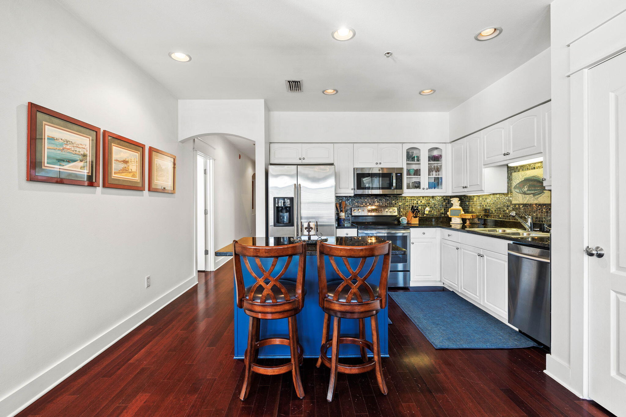 4545 East County Highway 30A, Unit B202 Santa Rosa Beach, FL 32459 - Photo 25 of 42 a kitchen with stainless steel appliances a dining table chairs and wooden floor