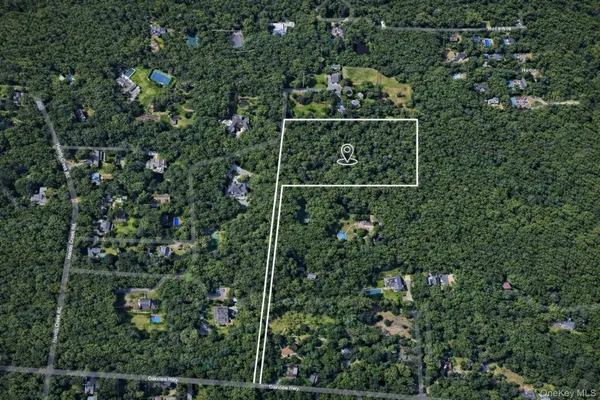 an aerial view of a house with a tree