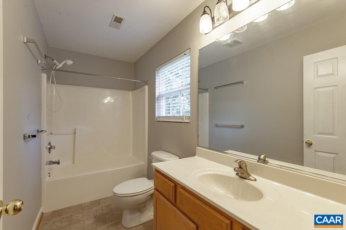 3 Bernardsburg Road Palmyra, VA 22963 - Photo 20 of 38 a bathroom with a sink toilet mirror vanity and shower