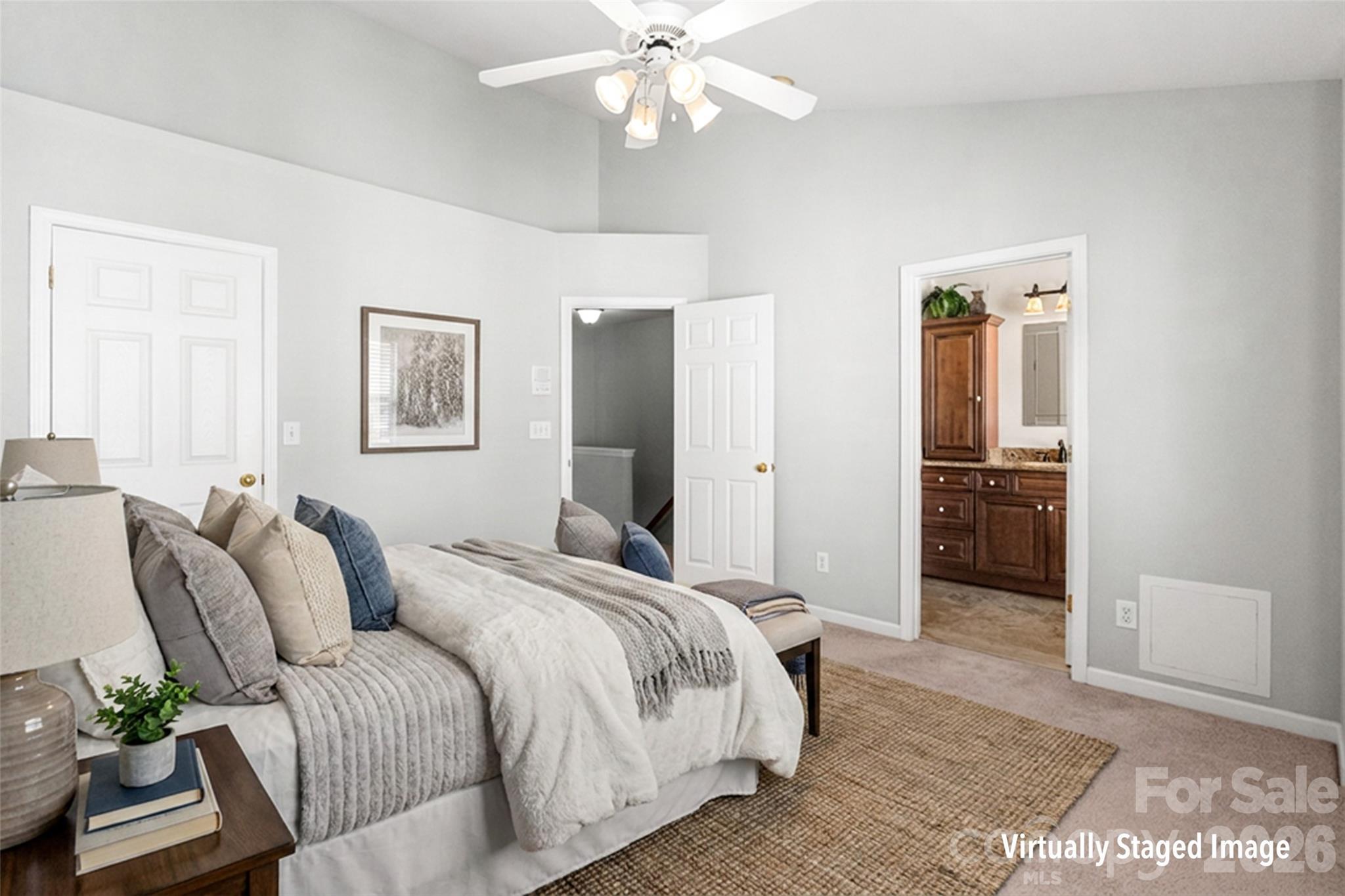 104 Rock Ridge Lane Mount Holly, NC 28120 - Photo 27 of 48 a spacious bedroom with a bed and a chandelier