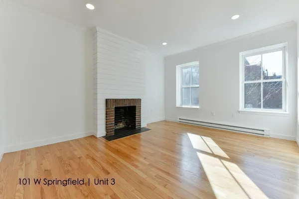 a view of empty room with window and fireplace
