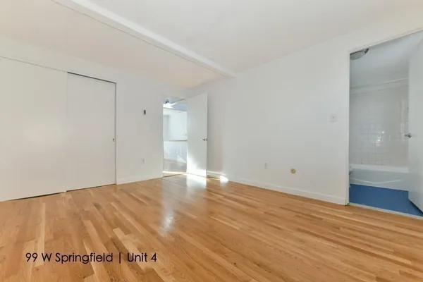 a view of an empty room and wooden floor