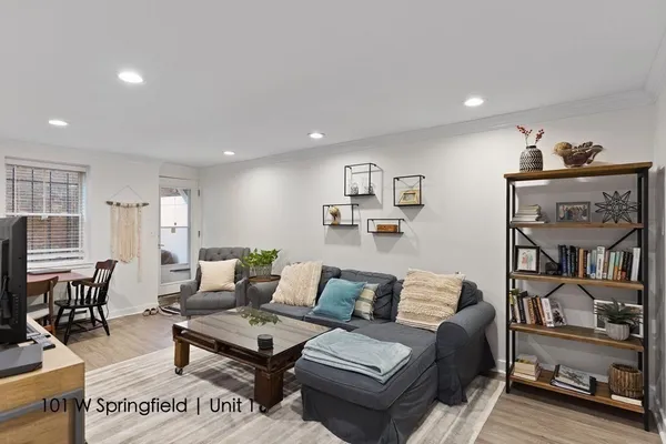 a living room with furniture and wooden floor