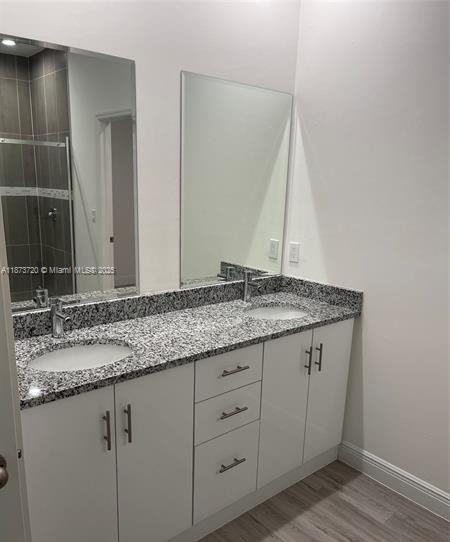 3034 East Briarwood Circle LaBelle, FL 33935 - Photo 4 of 6 a bathroom with a granite countertop sink and a mirror