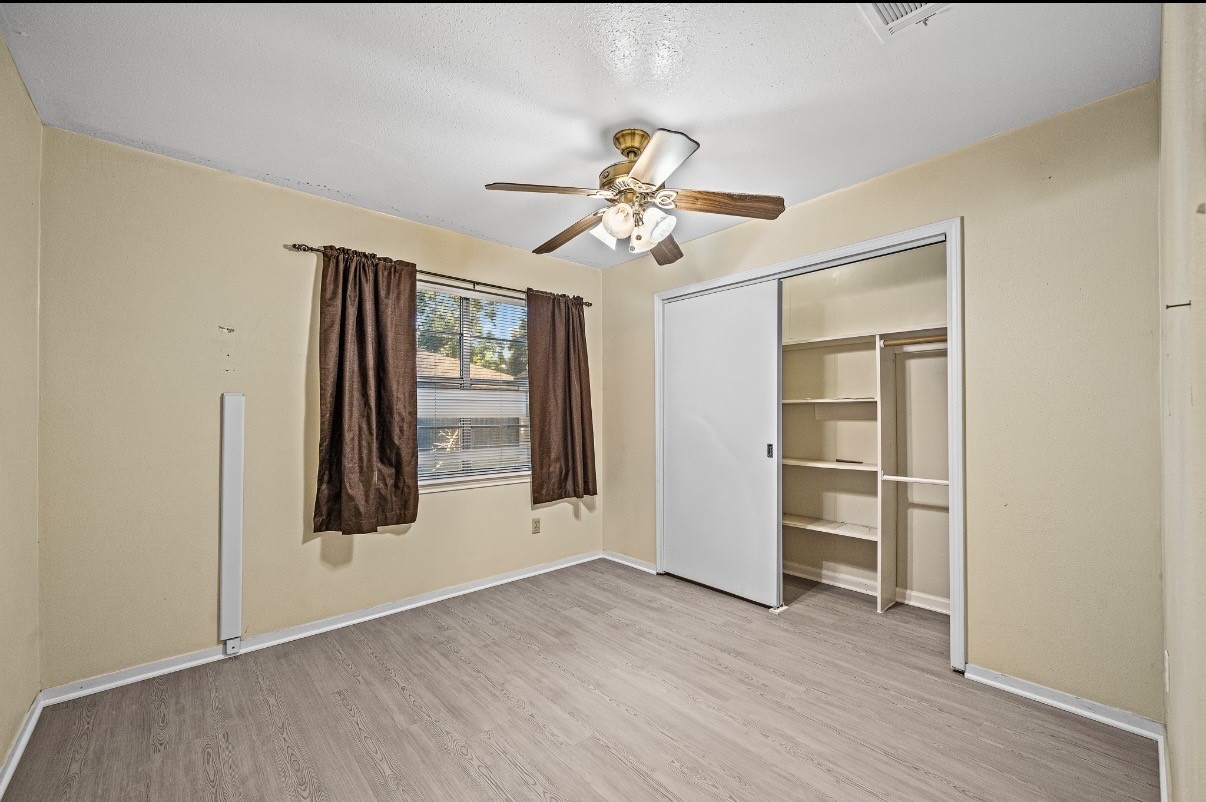 4822 Lost Oak Drive Spring, TX 77388 - Photo 11 of 14 a view of empty room with wooden floor and fan