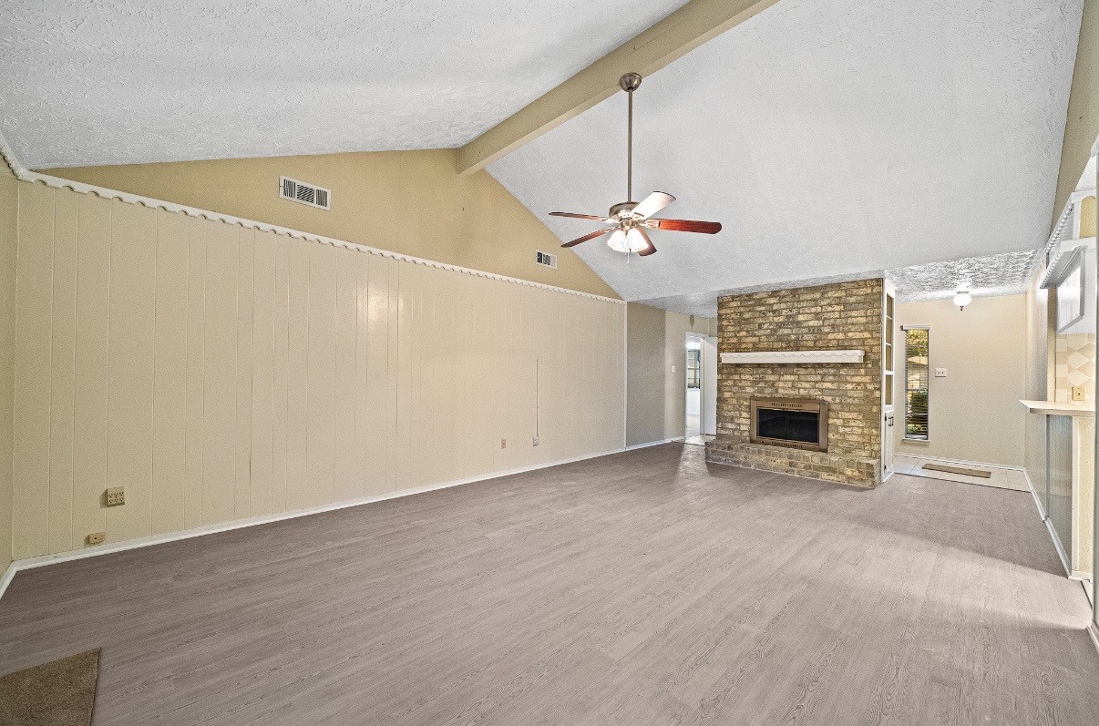 4822 Lost Oak Drive Spring, TX 77388 - Photo 5 of 14 an empty room with windows and fireplace