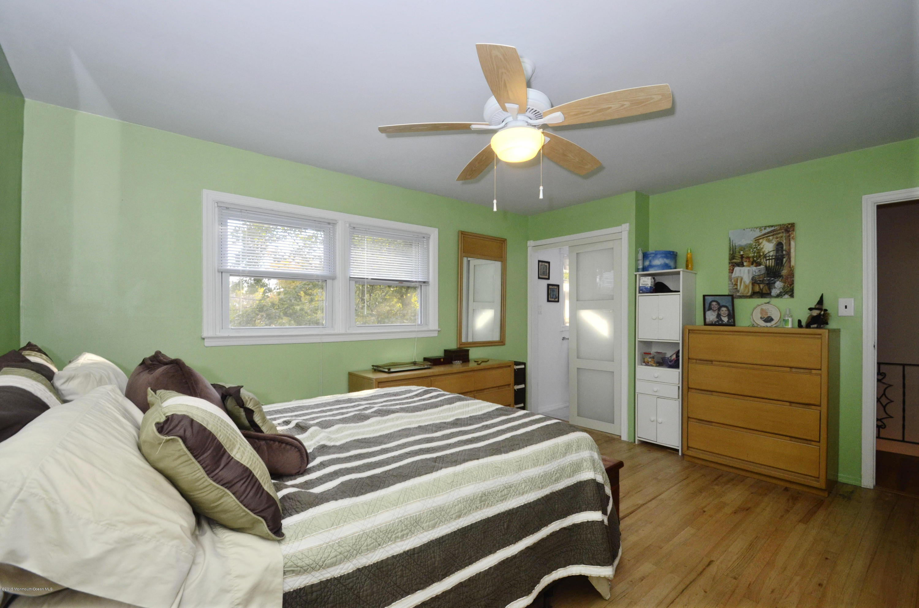 57 Middlesex Road Matawan, NJ 07747 - Photo 11 of 23 a bedroom with a bed and a chandelier