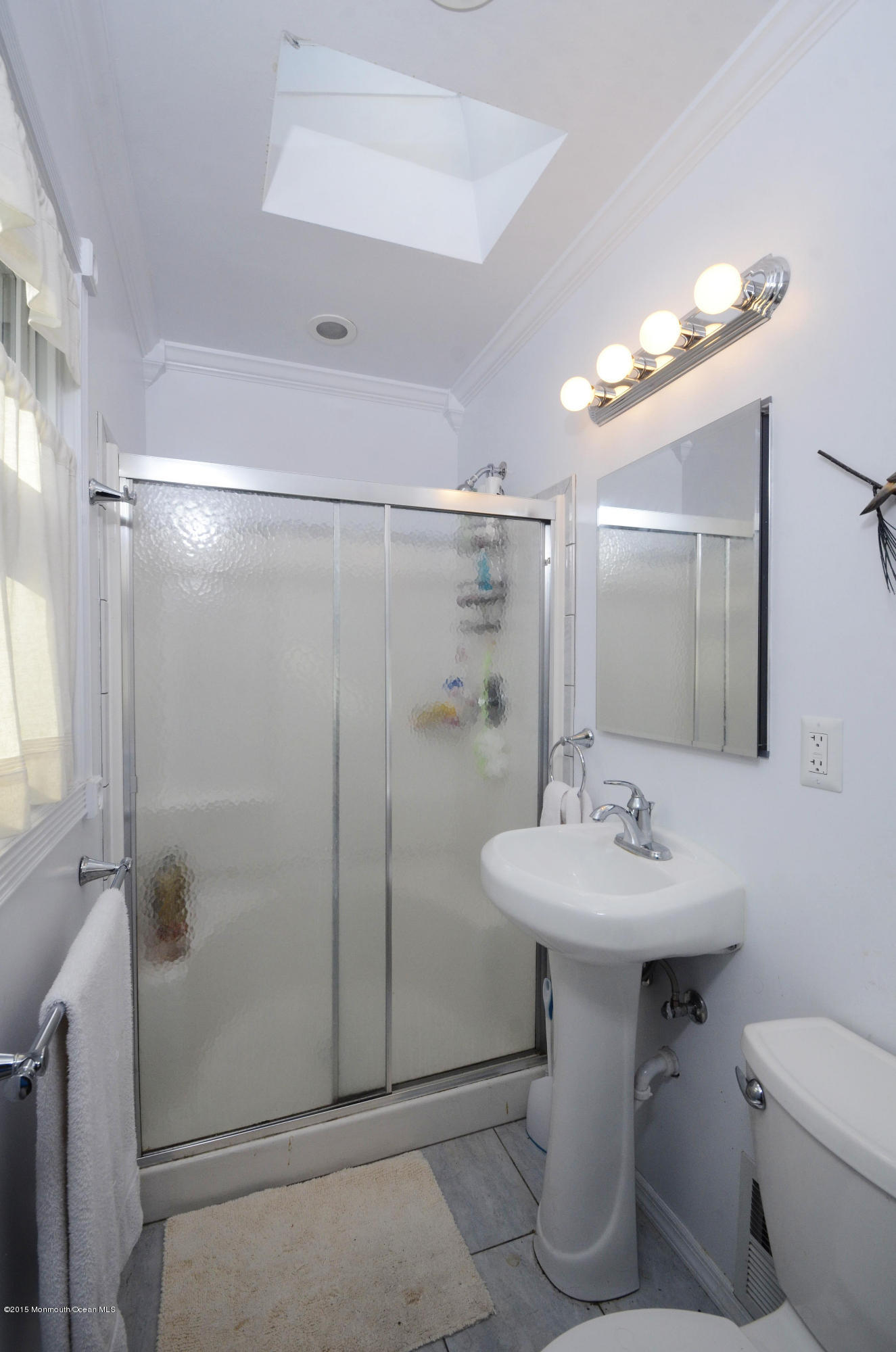 57 Middlesex Road Matawan, NJ 07747 - Photo 12 of 23 a bathroom with a sink mirror toilet and shower