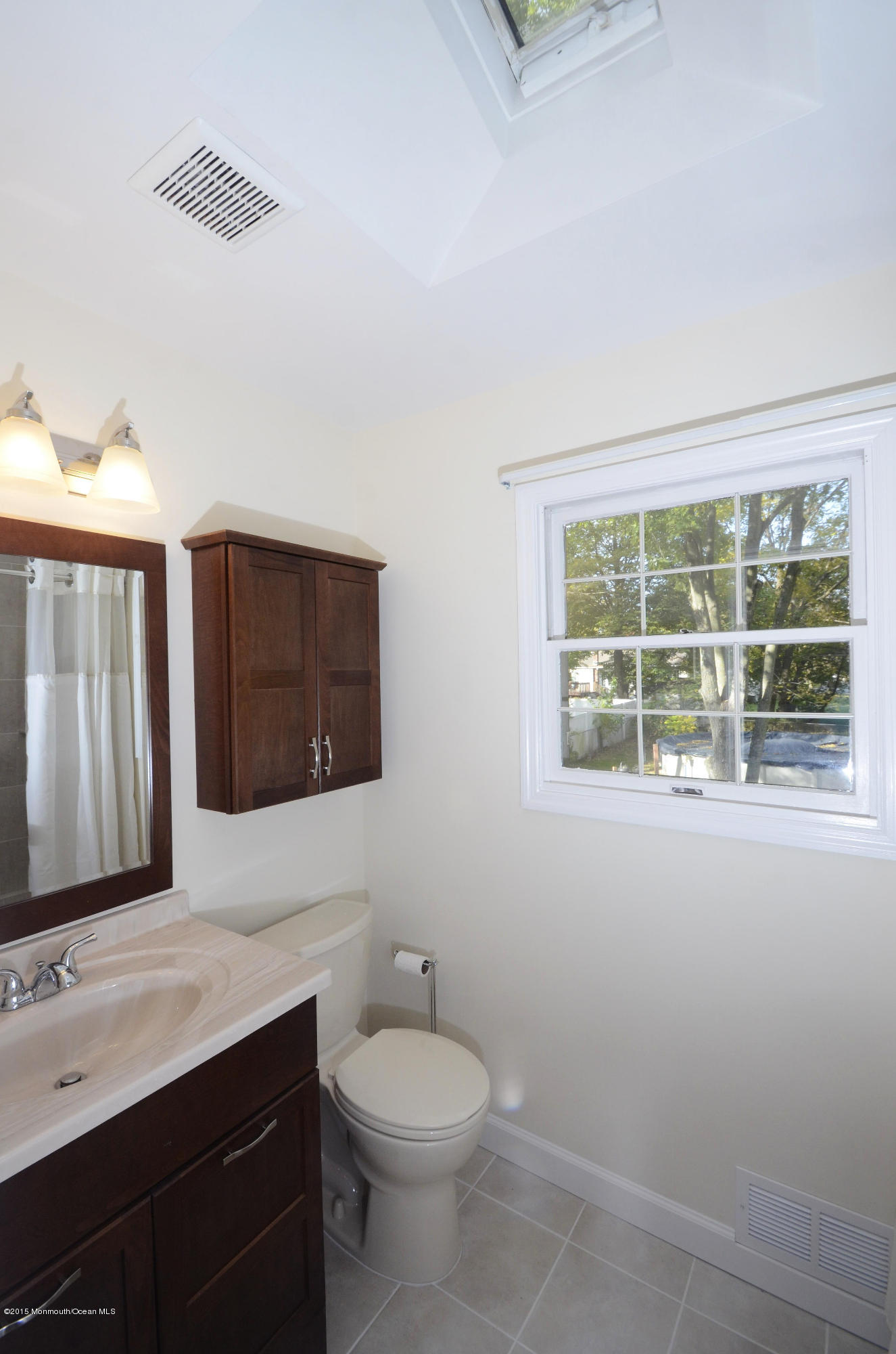 57 Middlesex Road Matawan, NJ 07747 - Photo 16 of 23 a bathroom with a toilet sink and mirror