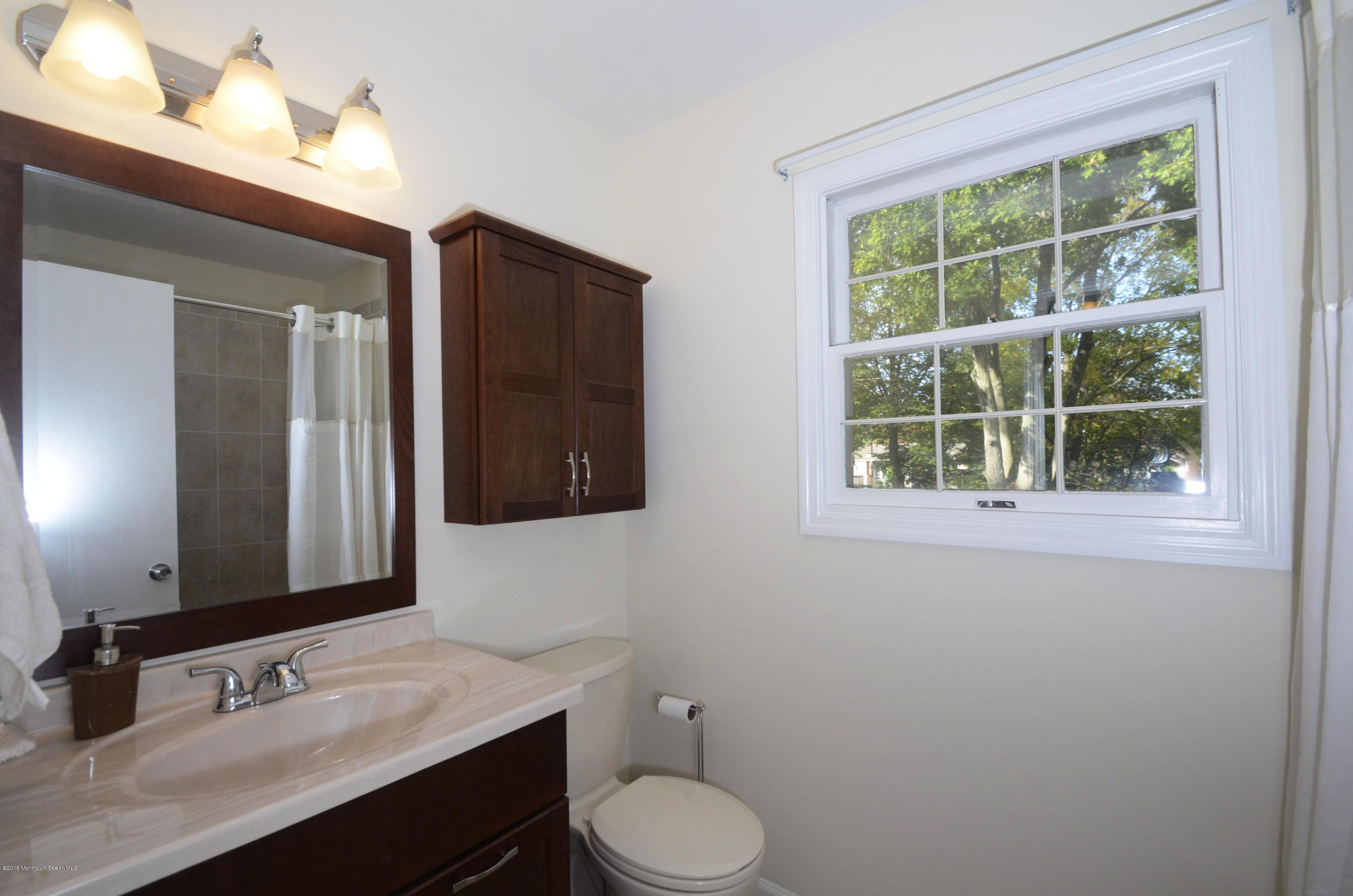 57 Middlesex Road Matawan, NJ 07747 - Photo 17 of 23 a bathroom with a toilet sink and mirror
