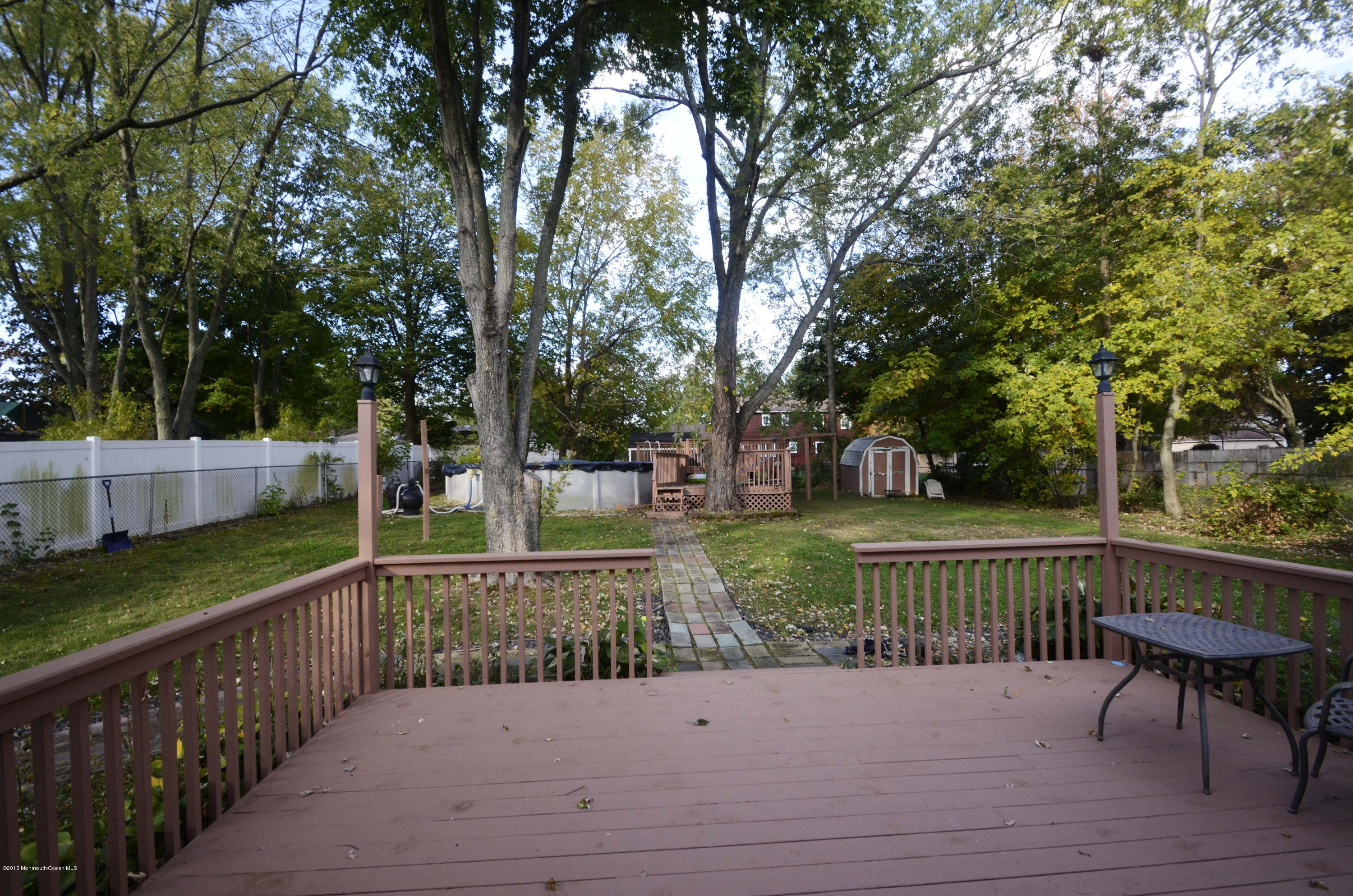 57 Middlesex Road Matawan, NJ 07747 - Photo 20 of 23 a view of a deck and yard with large trees