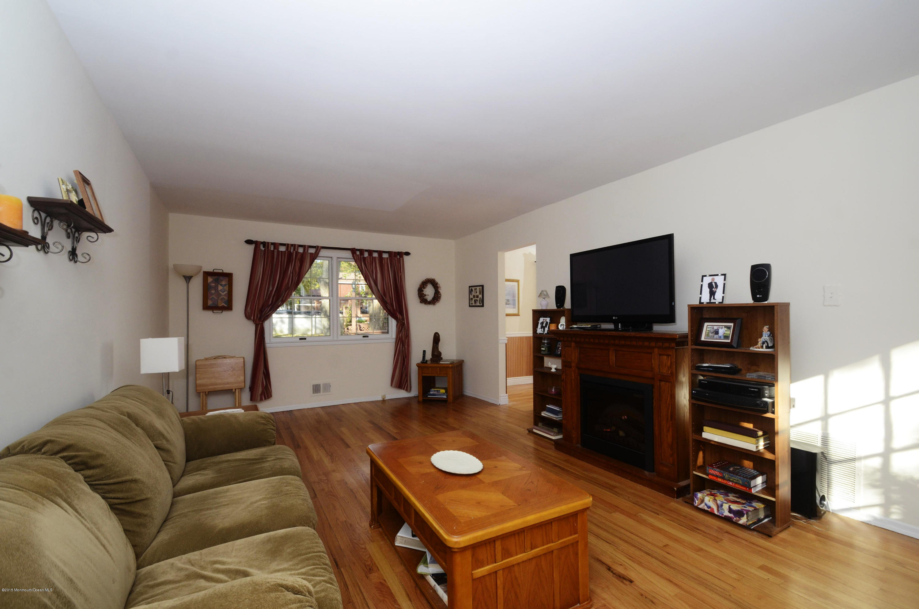 57 Middlesex Road Matawan, NJ 07747 - Photo 3 of 23 a living room with furniture a window and a flat screen tv