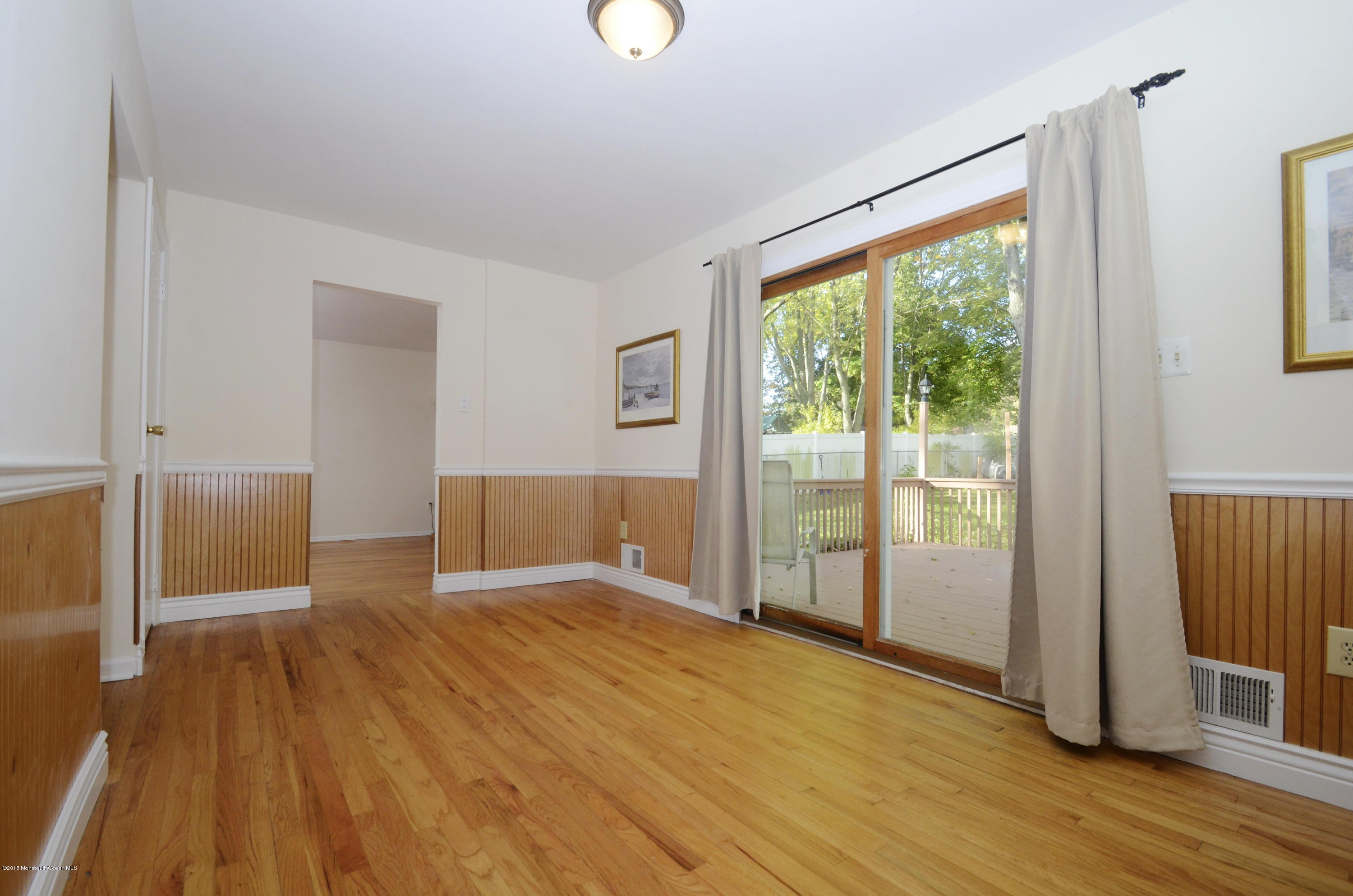 57 Middlesex Road Matawan, NJ 07747 - Photo 5 of 23 a view of an empty room with wooden floor and a window
