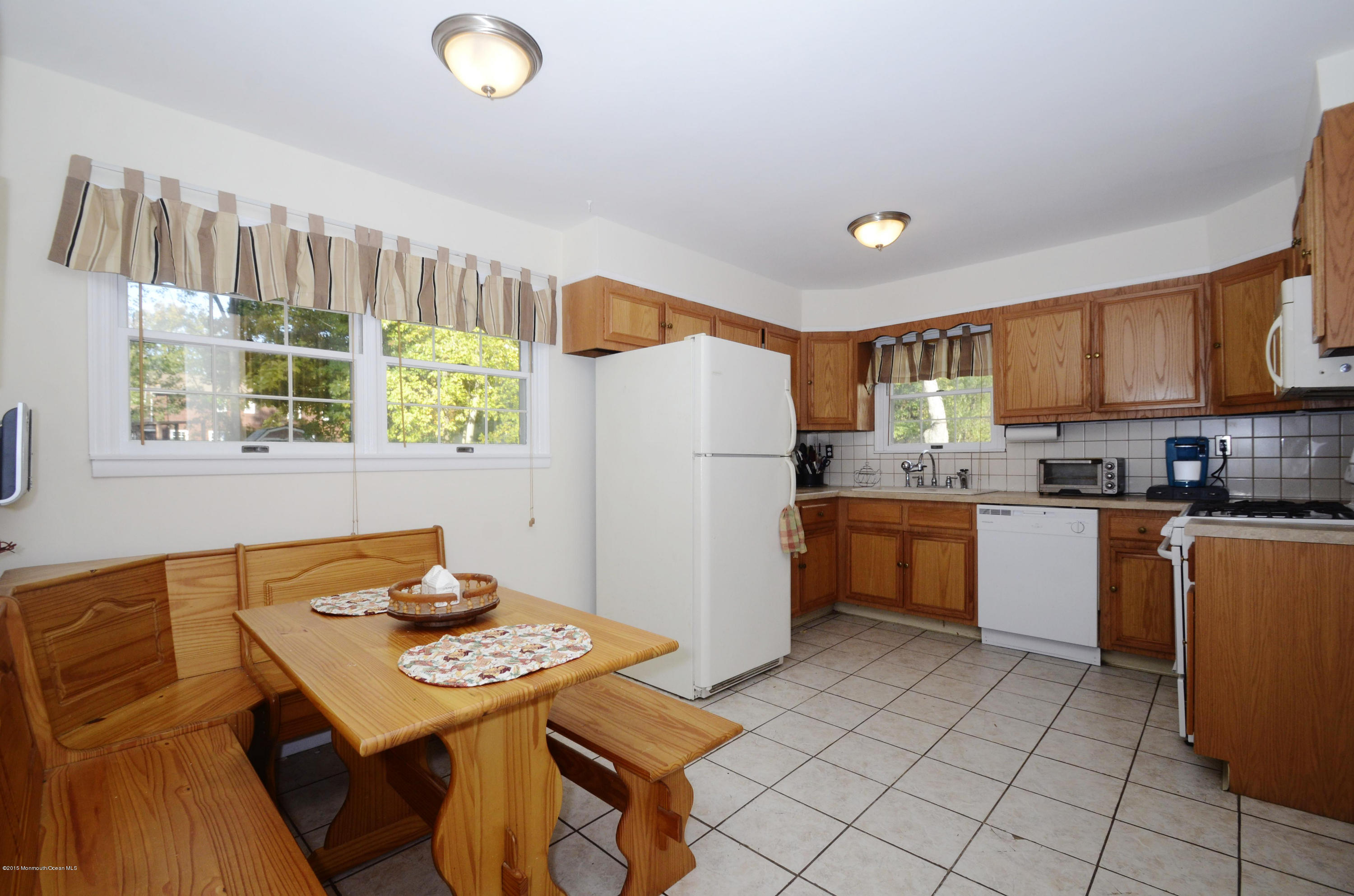 57 Middlesex Road Matawan, NJ 07747 - Photo 7 of 23 a kitchen with stainless steel appliances granite countertop a refrigerator a sink a stove a dining table and chairs