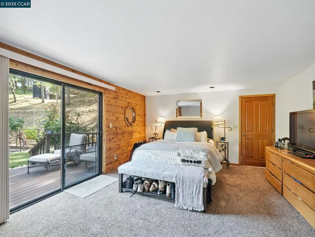 a bedroom with a bed and large window