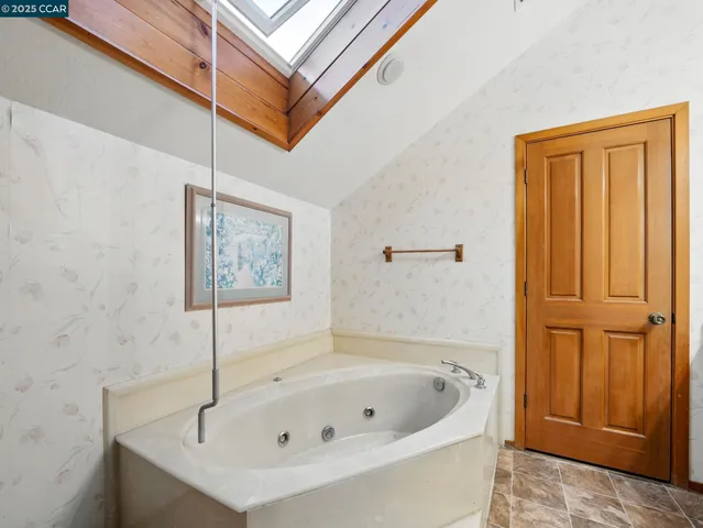 a bathroom with a tub and shower