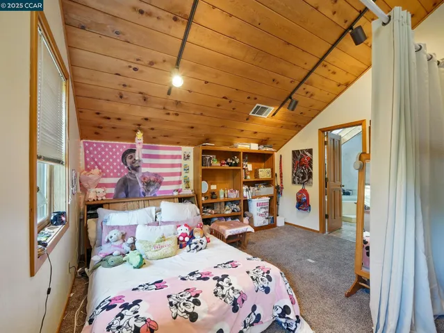 a bedroom with bed and window