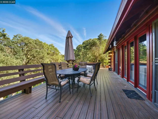 a view of a chairs and table on the wooden deck