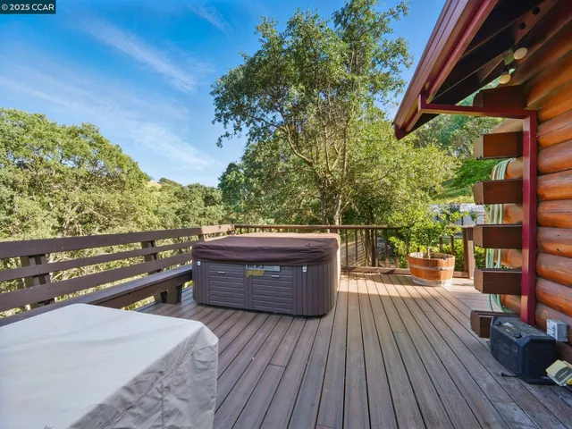 a view of deck with seating space and trees