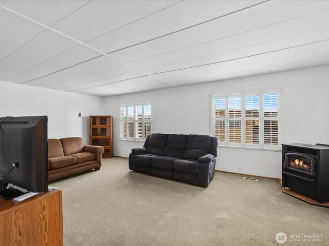 a living room with furniture window and a flat screen tv
